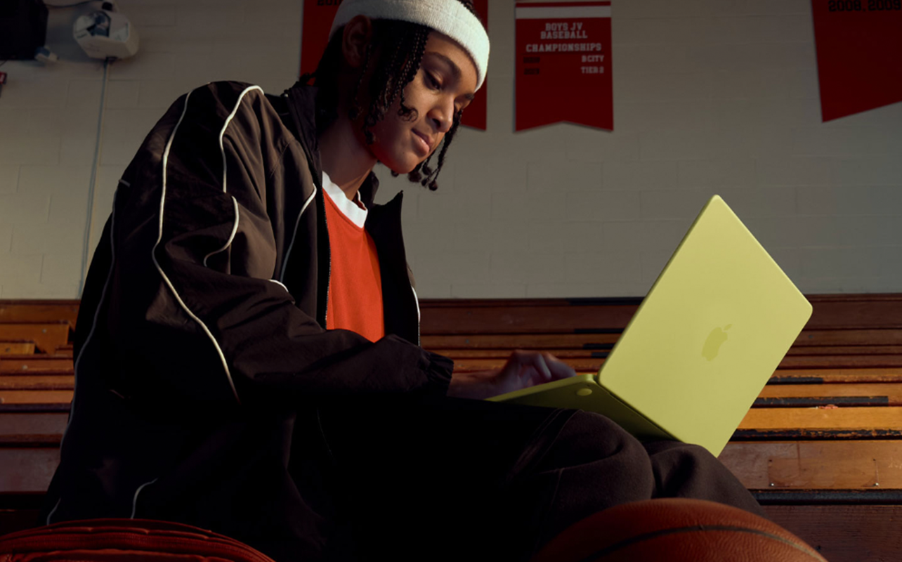 A young person with a MacBook Neo
