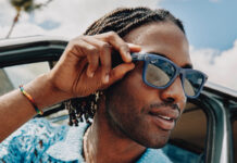 Man wearing Meta RayBan smart glasses in summer.