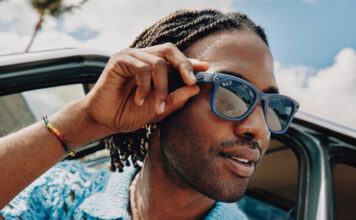 Man wearing Meta RayBan smart glasses in summer.