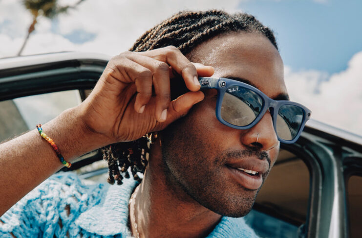 Man wearing Meta RayBan smart glasses in summer.