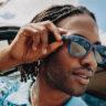 Man wearing Meta RayBan smart glasses in summer.
