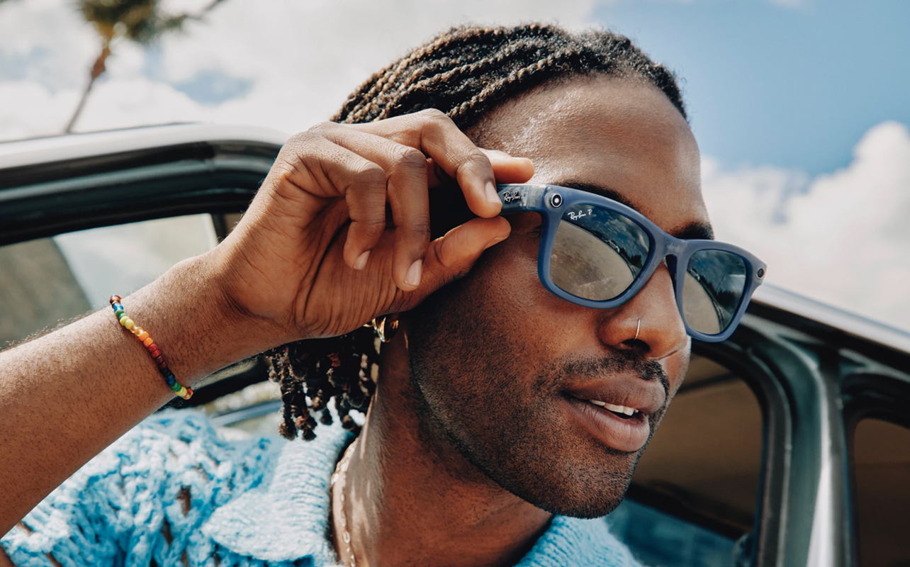 Man wearing Meta RayBan smart glasses in summer.
