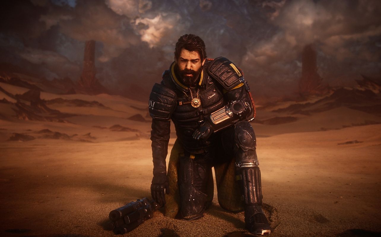 The lead character of the video game Saros takes a knee in the sand with a weapon next to him.