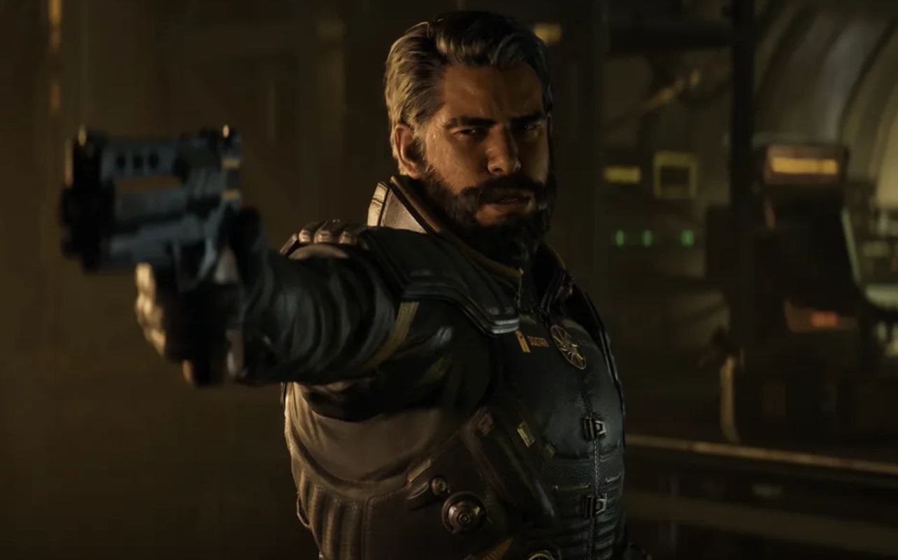 Arjun, a character from the video game Saros, points a gun at a figure outside of the frame. Tense mood.