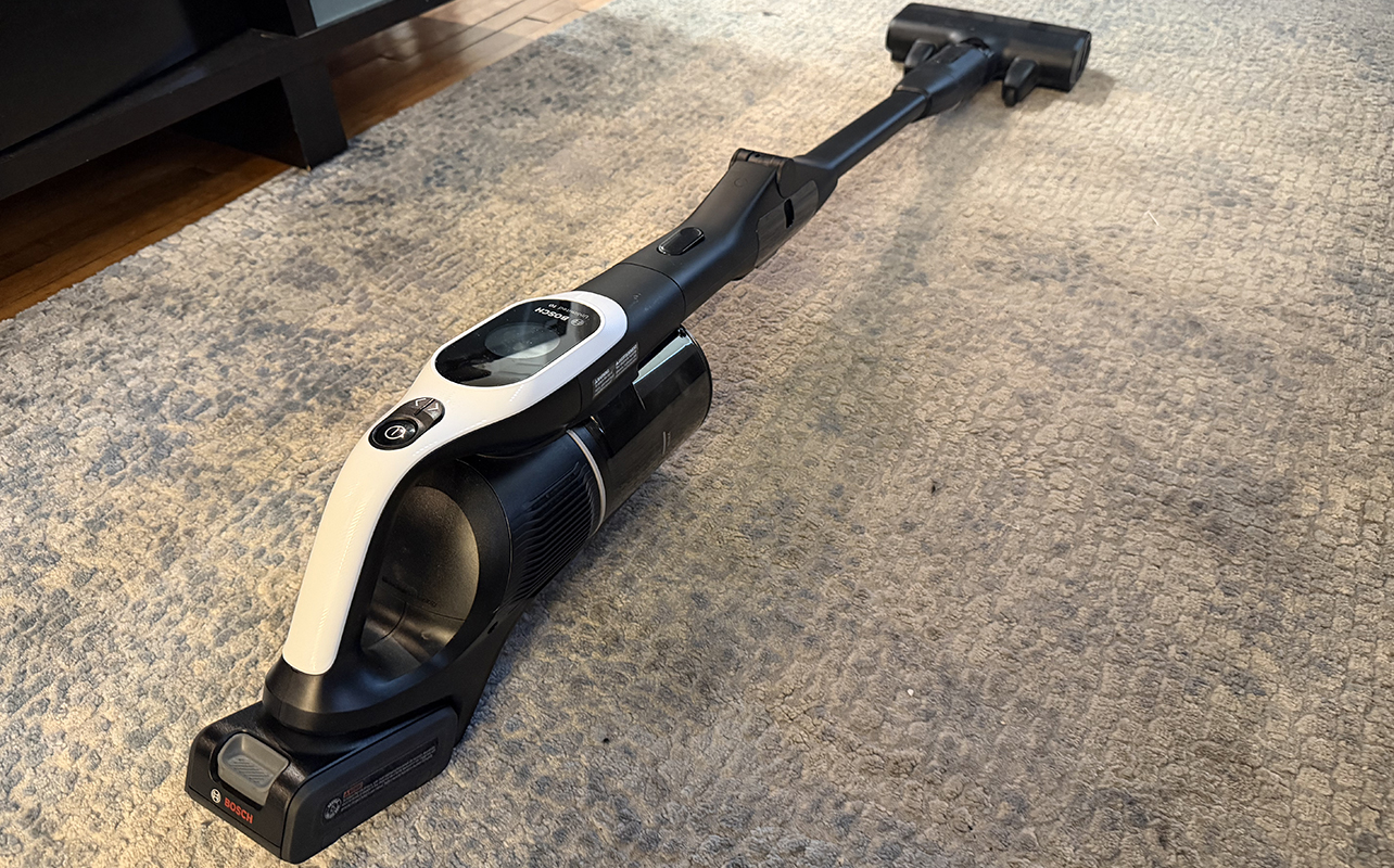 An angled image of the Bosch U10 cordless stick vacuum on a carpet.