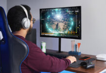 Do you really need the fastest internet speed available? A man sitting at a desk playing games on a computer with an eero Pro 6 mesh Wi-Fi node beside him.