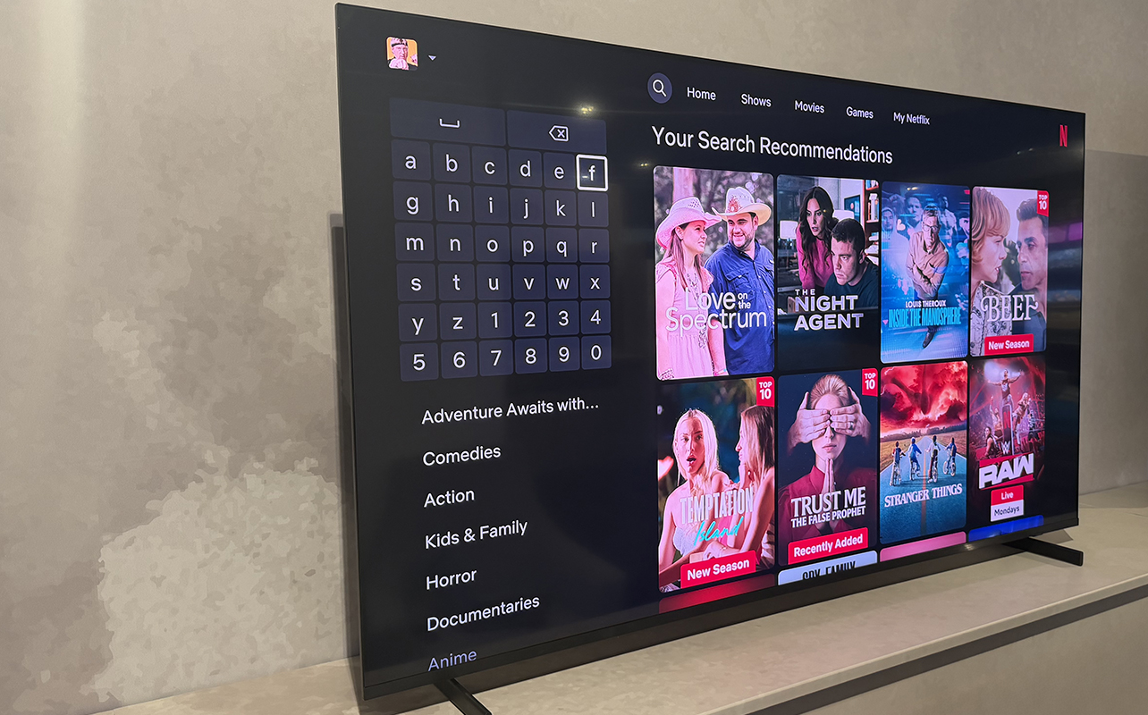 The Samsung R85H Micro RGB TV on a stand showing the Netflix search menu.