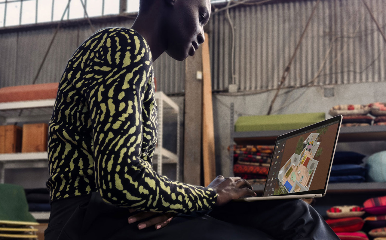 Person using MacBook for 3D design