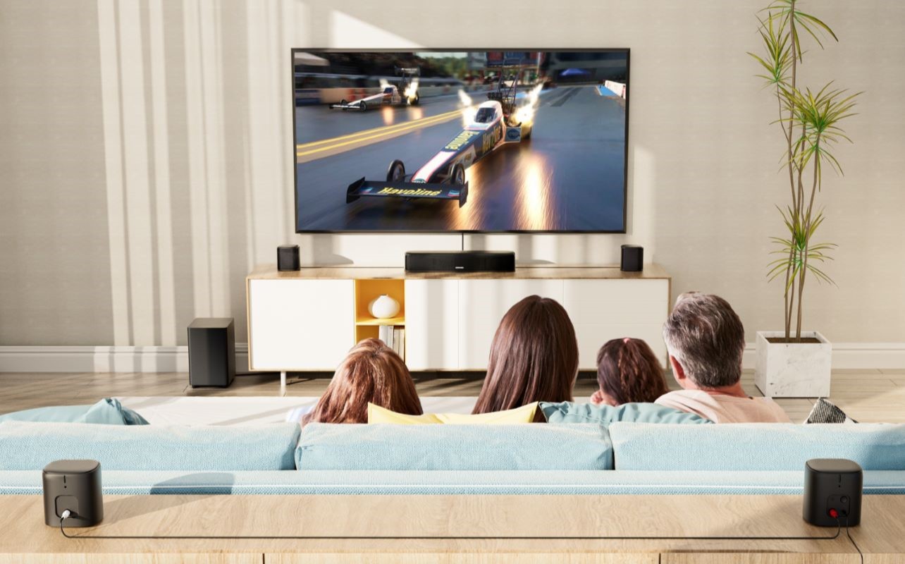 A family watches racing in a bright room.