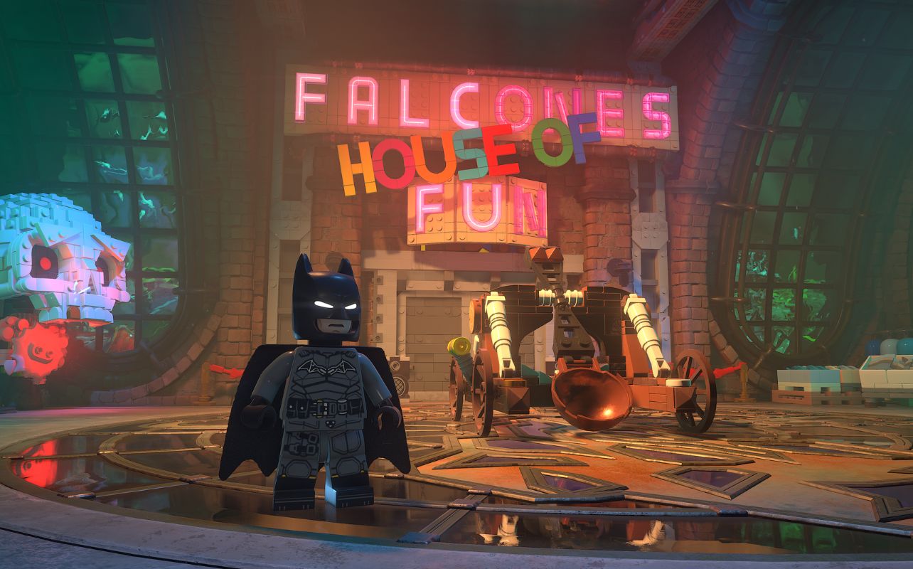 A screenshot of the Lego Batman: Legacy of the Dark Knight game with Batman with a fun background behind him.