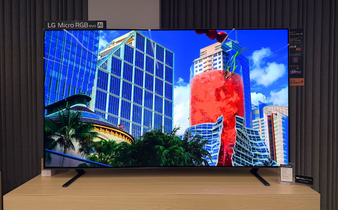 An LG TV with a vivid screen and blue skies and blue buildings displayed.
