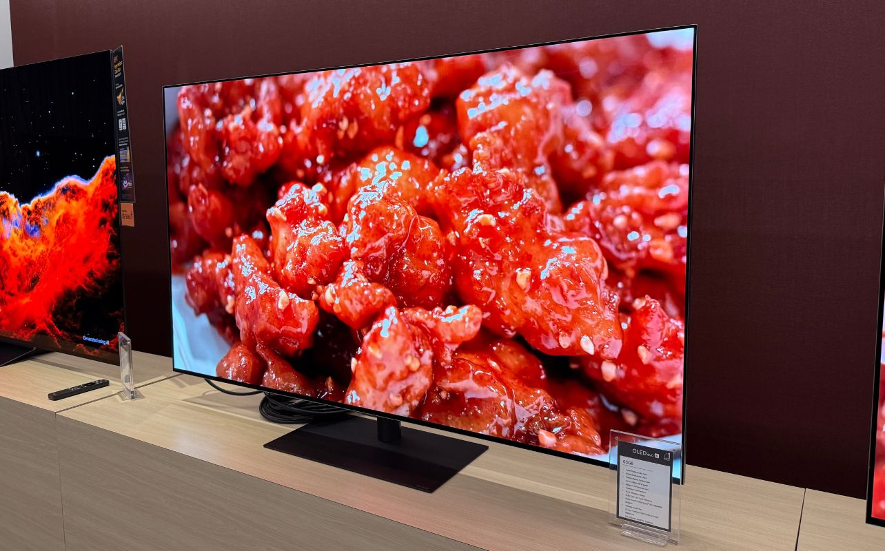 An LG TV displaying orange and reddish food on its display.
