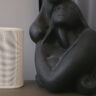 Sonos Play on a side table beside a sculpture.