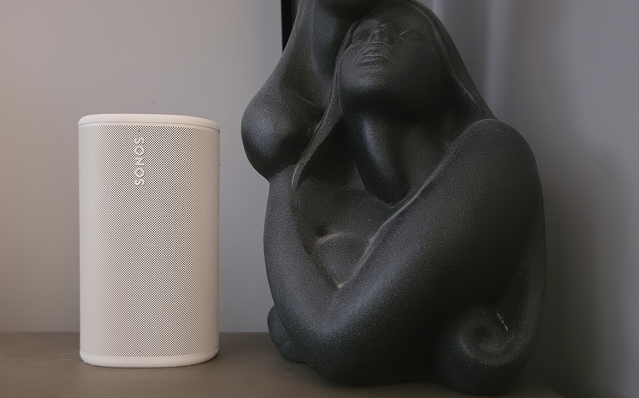 Sonos Play on a side table beside a sculpture.