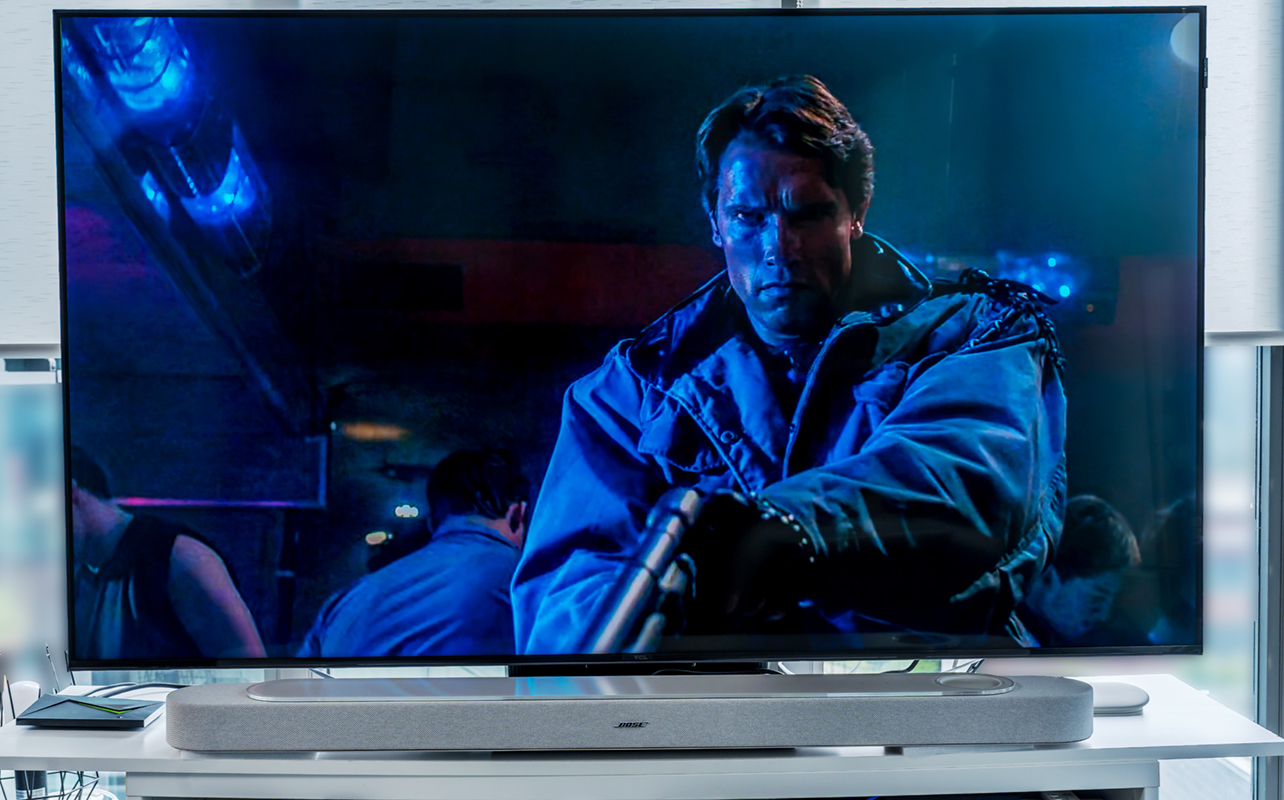 Movie playing on TV above Bose Lifestyle Ultra Soundbar.