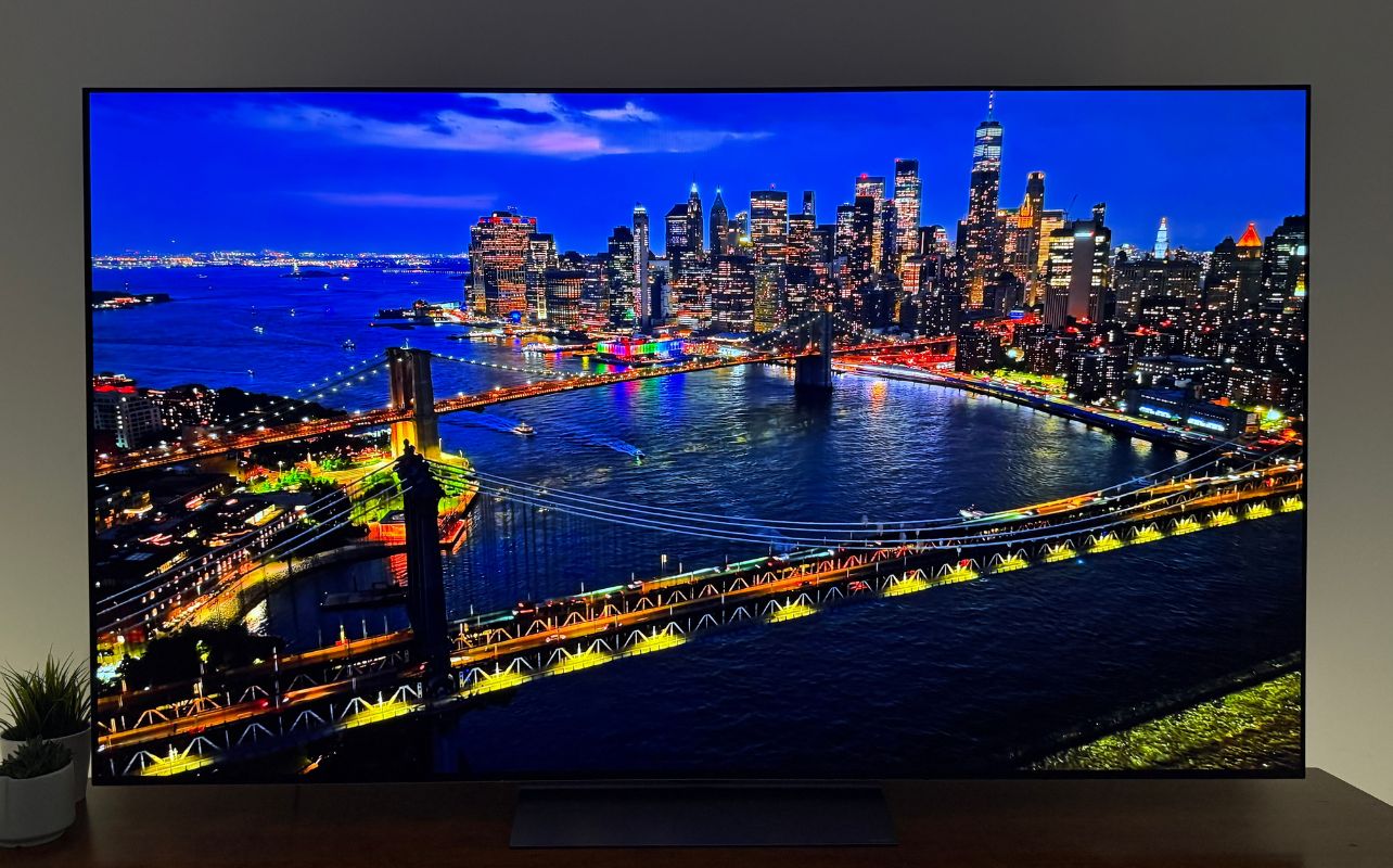 LG OLED 2026 C6H with a inky black city scene at night in a home theatre