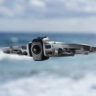 DJI Avata 360 in flight by the beach.