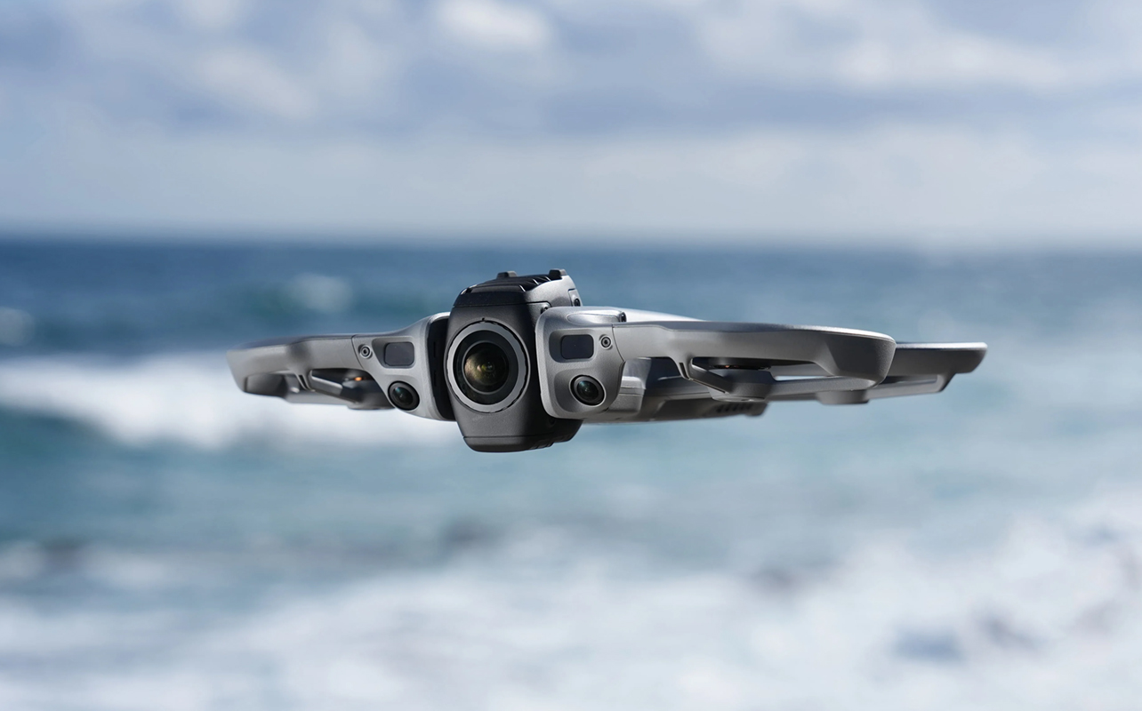 DJI Avata 360 in flight by the beach.