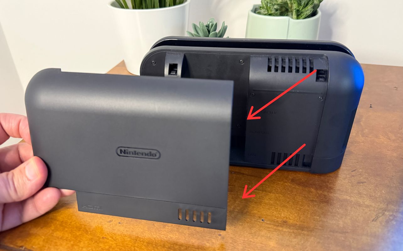 Nintendo Switch 2 Dock with someone removing the back plate.