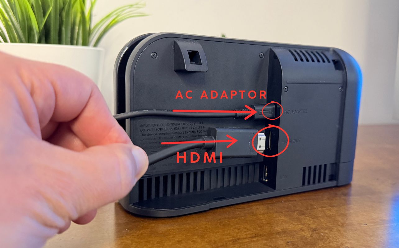 Nintendo Switch 2 Dock with Matthew Rondina plugging in the AC Adaptor and HDMI cable.