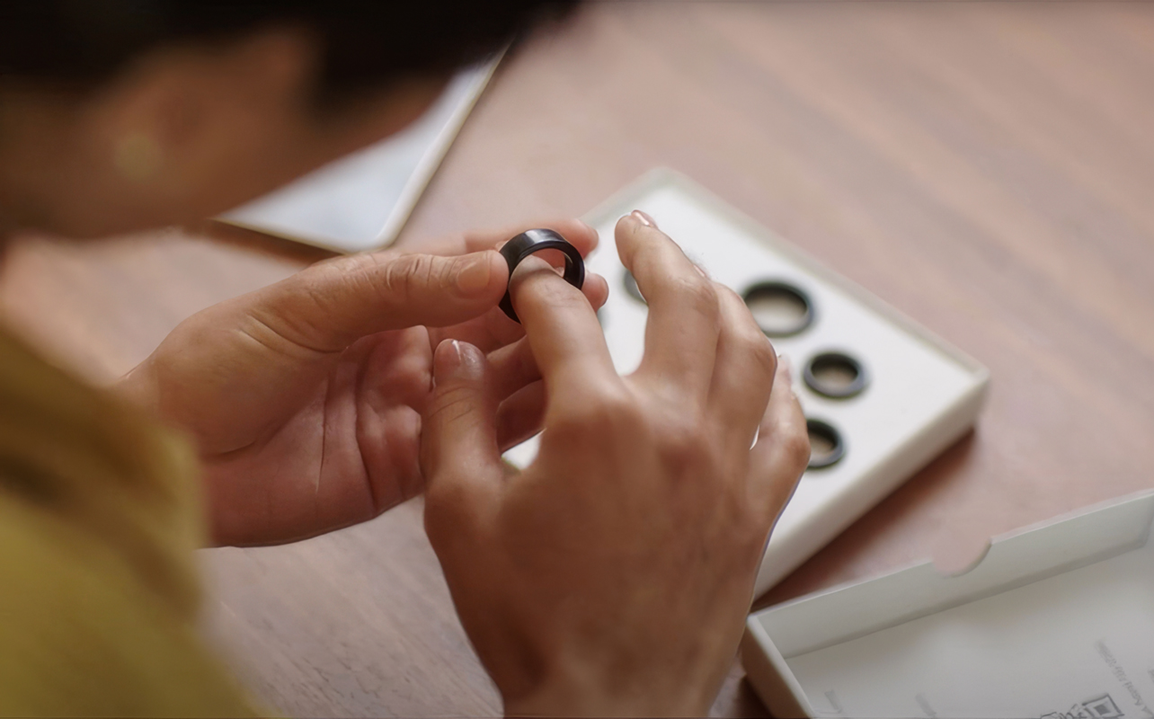 Person trying on Oura Ring via sizing kit.