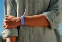 A person's arm across their body while wearing the Fitbit Air.