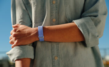 A person's arm across their body while wearing the Fitbit Air.