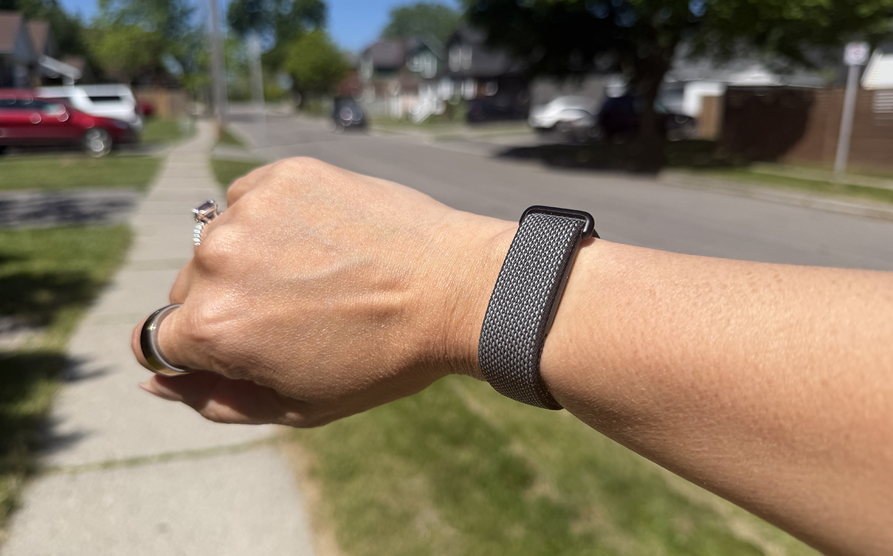 A wrist with the Fitbit Air outside.