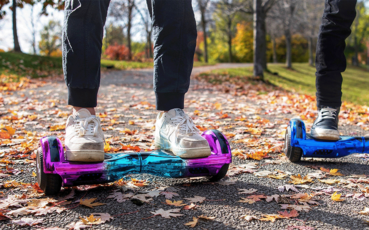 A couple of people riding their hoverboards.