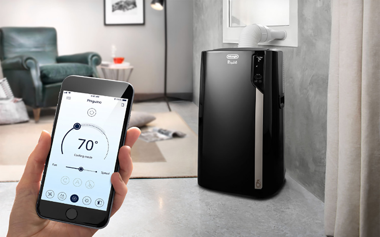 A hand holding the app for a Black & Decker portable air conditioner in the background.