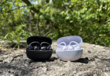 Shokz OpenDots 2 and OpenDots Air in their cases outside on a rock.