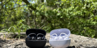 Shokz OpenDots 2 and OpenDots Air in their cases outside on a rock.