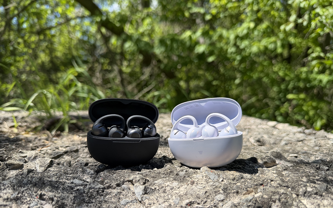 Shokz OpenDots 2 and OpenDots Air in their cases outside on a rock.