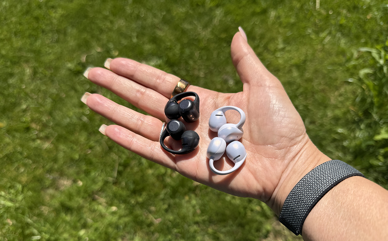 A Shokz OpenDots 2 and OpenDots Air bud in the palm of a hand.