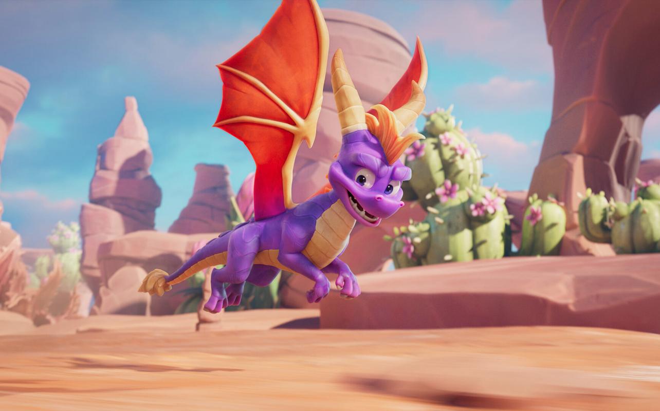 Spyro flying through a colourful desert area in Spyro: A Realm Beyond