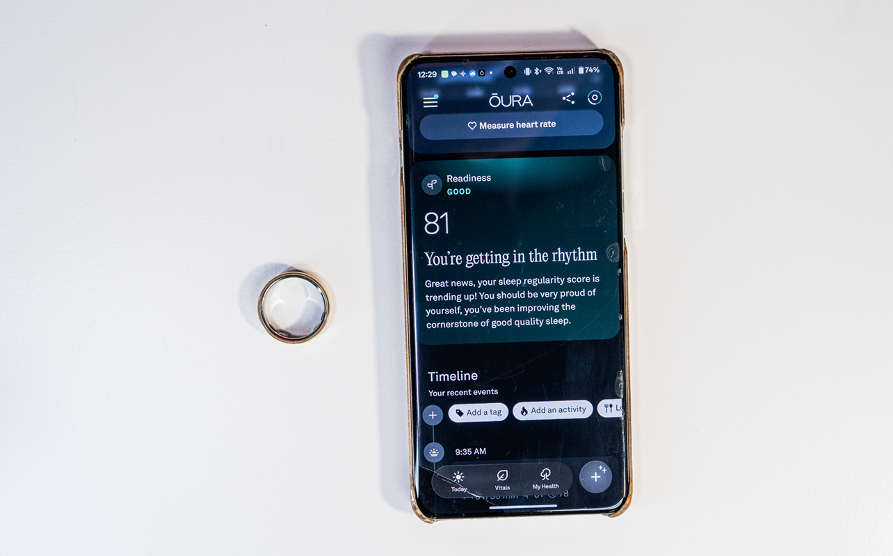 Oura Ring 5 next to phone with Oura app.