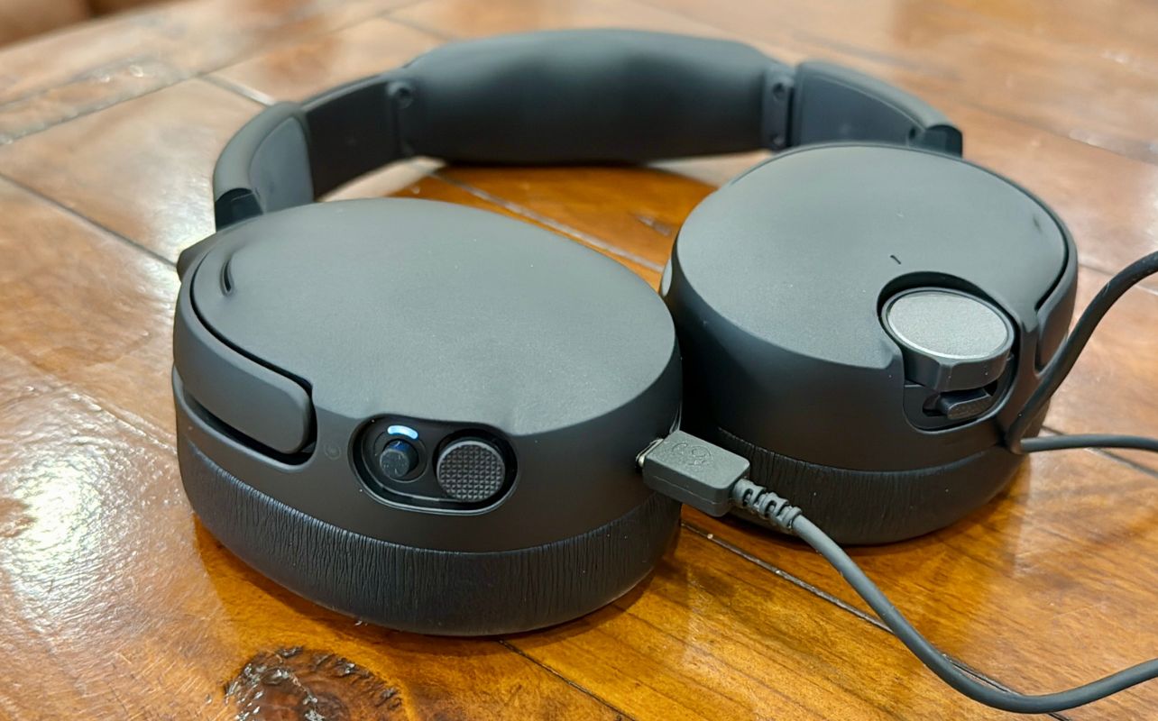 The Skullcandy Crusher 1080 ANC laid flat on a wood table.