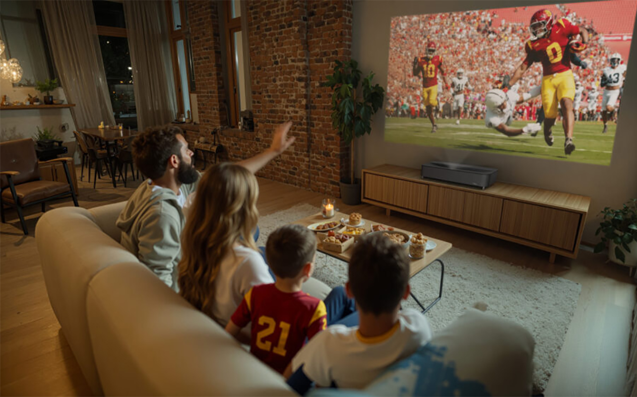 A family watching TV in the living room with the Epson Lifestudio Grand Plus projector.