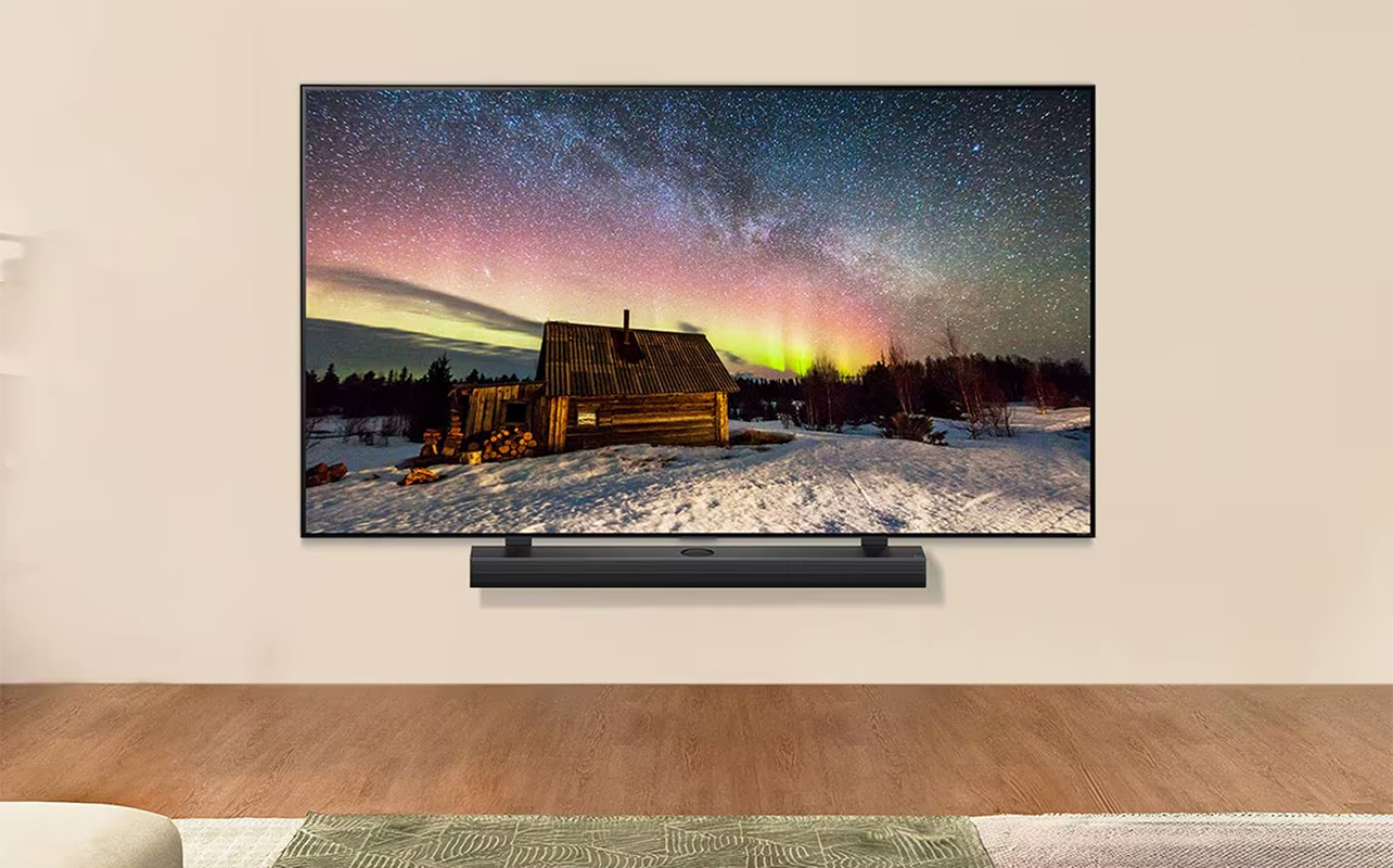 An LG AI TV mounted on a wall with a soundbar.