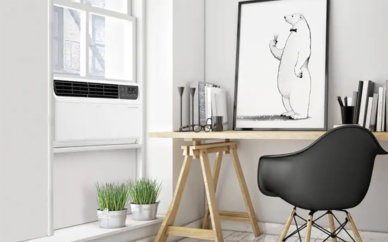 An LG smart window air conditioner in a window in a home office.