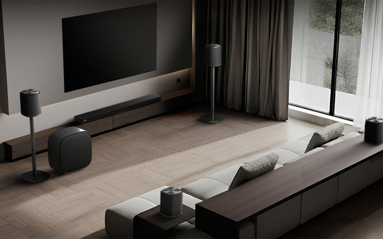 An overhead view of a living room setup with an LG Sound Suite sound bar and speakers.