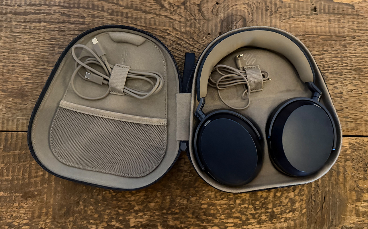 The Sennheiser Momentum 5 Wireless headphones in their case, open on a table.