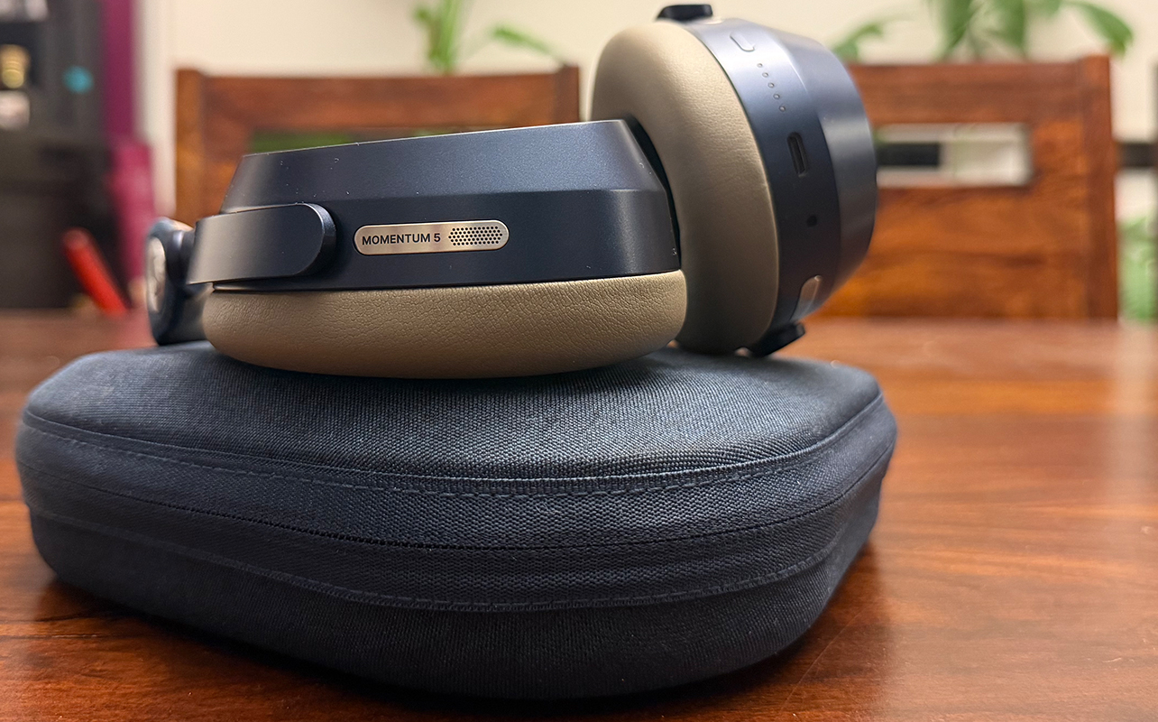 The Sennheiser Momentum 5 Wireless headphones atop their case in a Denim finish.