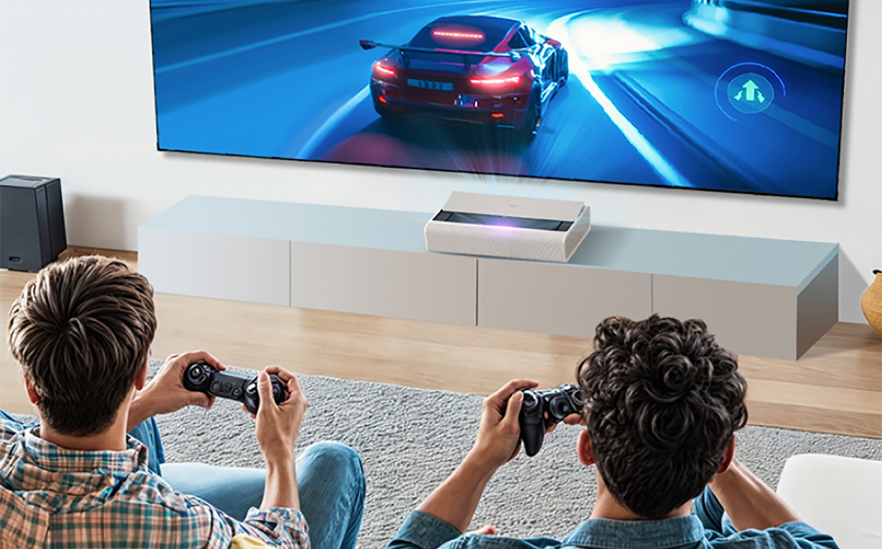 Two kids playing video games in a living room with the XGIMI Aura 2 ultra short throw projector.