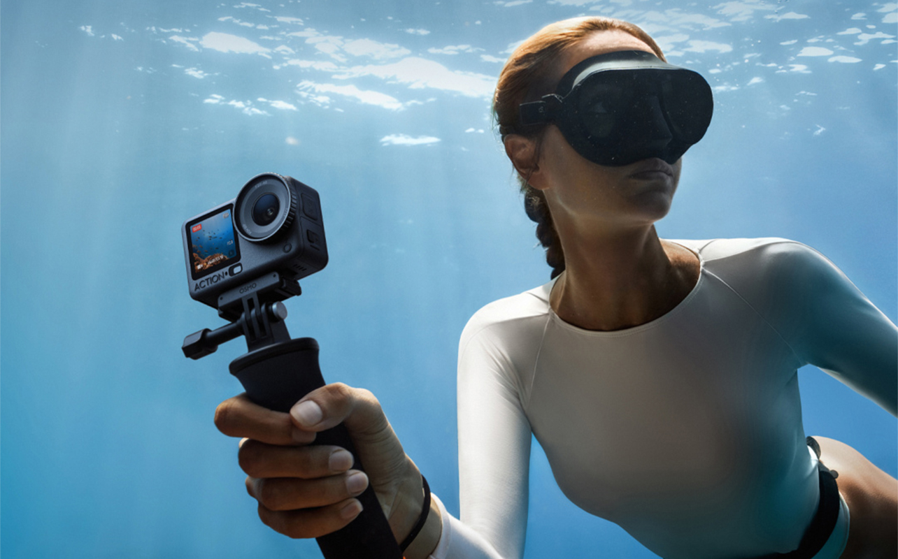 Woman diving underwater using DJI Osmo Action 6.