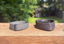 Fitbit Air and Garmin CIRQA side by side on a ledge outside.