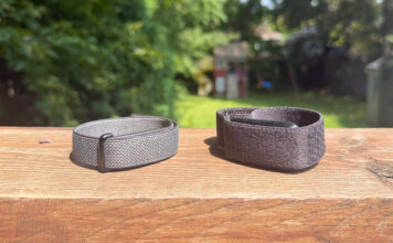 Fitbit Air and Garmin CIRQA side by side on a ledge outside.