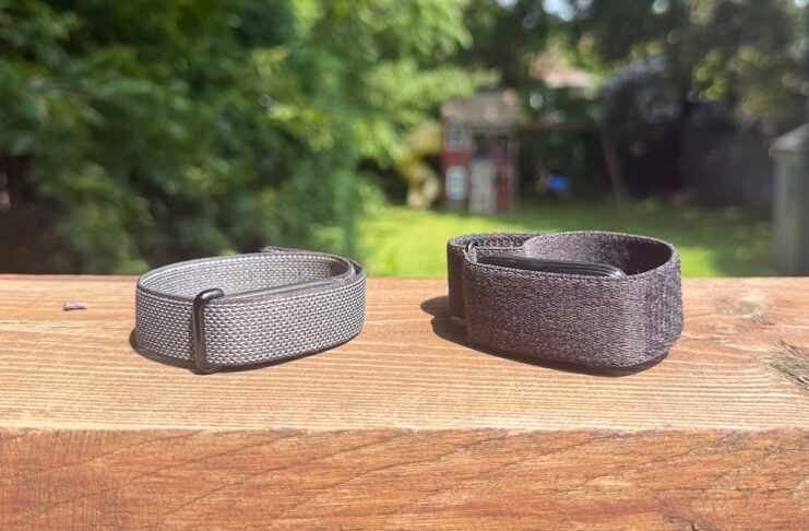 Fitbit Air and Garmin CIRQA side by side on a ledge outside.