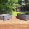 Fitbit Air and Garmin CIRQA side by side on a ledge outside.
