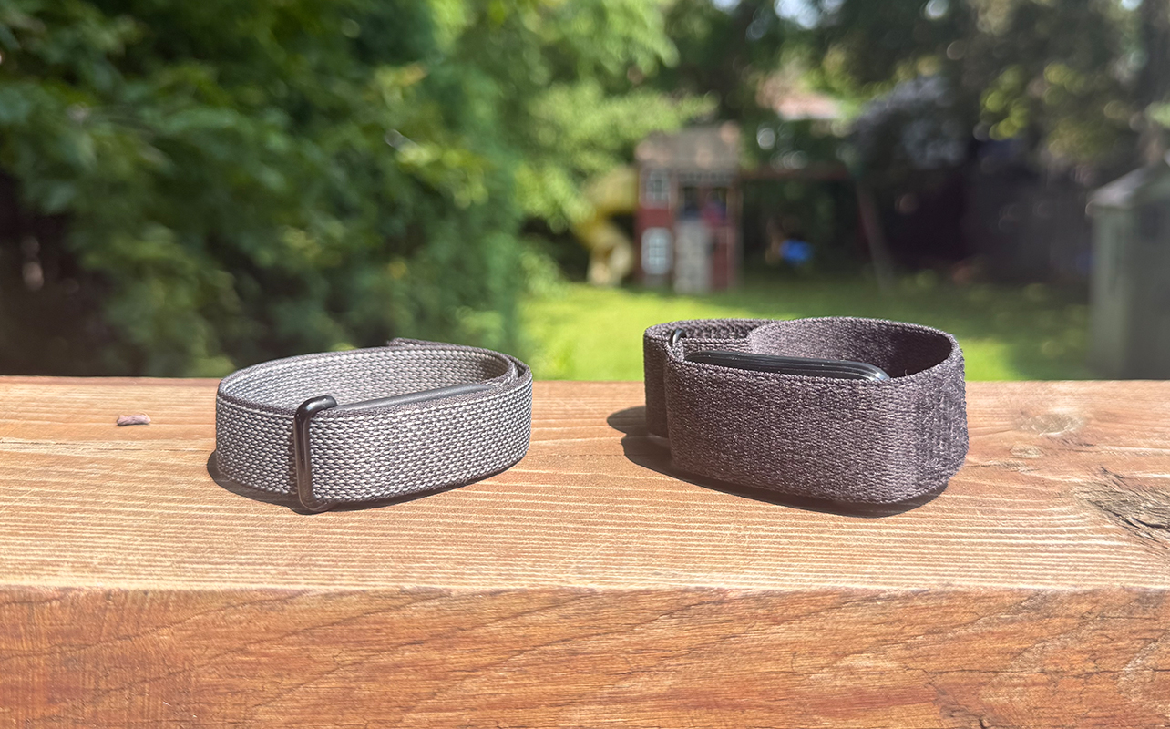 Fitbit Air and Garmin CIRQA side by side on a ledge outside.